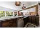 Convenient bar with sink, wooden cabinetry, and an open design for entertaining at 1200 Old Lathemtown Rd, Canton, GA 30115