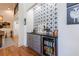 Stylish bar area with gray cabinets, black countertop, beverage cooler and decorative tile wall at 1200 Old Lathemtown Rd, Canton, GA 30115