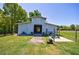 This exterior features a pale barn with green grass, fences, landscaping, and blue skies at 1200 Old Lathemtown Rd, Canton, GA 30115