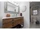 Bathroom featuring a rustic wood vanity with marble countertop, framed mirror, and decorative wall decor at 1200 Old Lathemtown Rd, Canton, GA 30115