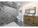Bathroom featuring a vanity with a wooden design, herringbone shower tile and pebble stone floor at 1200 Old Lathemtown Rd, Canton, GA 30115