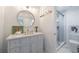 Modern bathroom with a vanity, round mirror, marble floors, and glass-enclosed shower at 1200 Old Lathemtown Rd, Canton, GA 30115