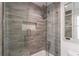 Bathroom featuring a glass door shower with wooden-like tile, built-in niche, and a shower head at 1200 Old Lathemtown Rd, Canton, GA 30115