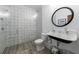 This elegant bathroom features patterned tile, a glass shower, and a unique sink with a round mirror at 1200 Old Lathemtown Rd, Canton, GA 30115