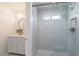 Bathroom showcasing a walk-in shower with glass doors, white tiled walls, and vanity at 1200 Old Lathemtown Rd, Canton, GA 30115