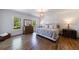 Bedroom with hardwood floors, windows with backyard views, and a neutral colored bed at 1200 Old Lathemtown Rd, Canton, GA 30115