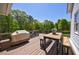 Spacious deck with outdoor dining and grilling area, perfect for entertaining, and wooded view at 1200 Old Lathemtown Rd, Canton, GA 30115