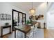 Dining room with wooden table, black framed sliding doors to deck, and modern decor at 1200 Old Lathemtown Rd, Canton, GA 30115