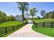 Scenic driveway leading to a charming home with lush green lawns and mature trees at 1200 Old Lathemtown Rd, Canton, GA 30115