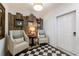Charming entryway with cozy chairs, rustic decor, and a black and white checkered rug at 1200 Old Lathemtown Rd, Canton, GA 30115