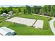 Aerial view of the equestrian arena with adjacent barn and surrounding green pastures at 1200 Old Lathemtown Rd, Canton, GA 30115