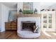 Farmhouse-style living room with white painted brick fireplace with wooden beam mantel at 1200 Old Lathemtown Rd, Canton, GA 30115