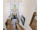 View from the top of the staircase to foyer with modern chandelier and front door entrance at 1200 Old Lathemtown Rd, Canton, GA 30115
