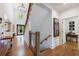 Two-story foyer with hardwood floors, rustic railing, and an open floor plan leading to the kitchen at 1200 Old Lathemtown Rd, Canton, GA 30115
