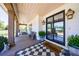 Inviting front porch with black and white checkered rug and lantern-style lighting at 1200 Old Lathemtown Rd, Canton, GA 30115
