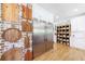 Bright kitchen featuring stainless steel refrigerator, brick accent wall, and white cabinets at 1200 Old Lathemtown Rd, Canton, GA 30115
