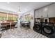 Well-lit laundry room with a stylish gray and white patterned rug and modern front-load washer and dryer units at 1200 Old Lathemtown Rd, Canton, GA 30115