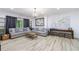Comfortable living room with stylish couches, wood-look flooring, and ample natural light at 1200 Old Lathemtown Rd, Canton, GA 30115