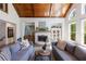 Cozy living room with high ceilings, wood beams, large windows, fireplace, and hardwood floors at 1200 Old Lathemtown Rd, Canton, GA 30115