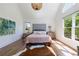 Bright main bedroom featuring vaulted ceilings, hardwood floors, large windows, and stylish decor at 1200 Old Lathemtown Rd, Canton, GA 30115