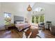 Bright, airy main bedroom with high ceilings, hardwood floors, a decorative headboard, and large windows at 1200 Old Lathemtown Rd, Canton, GA 30115