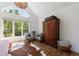 Bright main bedroom featuring vaulted ceilings, hardwood floors, a sitting area, and stylish decor at 1200 Old Lathemtown Rd, Canton, GA 30115