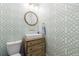 Stylish powder room with designer wallpaper, vessel sink on a dresser, and gold-tone accents at 1200 Old Lathemtown Rd, Canton, GA 30115