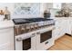 Close-up of a high-end range with stainless steel accents and white cabinetry at 1200 Old Lathemtown Rd, Canton, GA 30115
