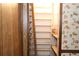 Open pantry with white shelving, with dark wood paneling to the left and wallpaper on the right at 3043 Alston Dr, Decatur, GA 30032