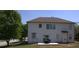 Backyard view of a two-story home with a white exterior, patio, and green lawn at 3152 Spruce Way, Atlanta, GA 30349