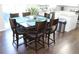 Bright dining area with a dark wood table, six chairs, and view to the kitchen at 3152 Spruce Way, Atlanta, GA 30349