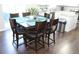 Dining area showcasing a wood table, six chairs, and stainless steel trash receptacle at 3152 Spruce Way, Atlanta, GA 30349