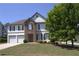 Traditional two-story home with a well-manicured lawn, two-car garage and neutral color palette at 3152 Spruce Way, Atlanta, GA 30349