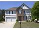 Traditional two-story home with a well-manicured lawn, two-car garage and neutral color palette at 3152 Spruce Way, Atlanta, GA 30349
