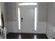 Inviting foyer with a bright white front door, sidelights, and dark wood flooring at 3152 Spruce Way, Atlanta, GA 30349