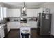Modern kitchen featuring stainless steel appliances, granite countertops, and white cabinets at 3152 Spruce Way, Atlanta, GA 30349