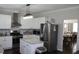 Modern kitchen featuring white cabinets, stainless steel appliances, and a stylish backsplash at 3152 Spruce Way, Atlanta, GA 30349