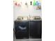 Laundry room features a gray front loading washer and dryer set with a wire shelf at 3152 Spruce Way, Atlanta, GA 30349