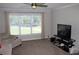 Cozy living room featuring plush carpeting and a large window with natural light at 3152 Spruce Way, Atlanta, GA 30349