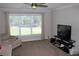 Cozy living room with neutral walls, ceiling fan, and a large window letting in natural light at 3152 Spruce Way, Atlanta, GA 30349
