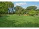 Expansive backyard with lush green grass and mature trees at 785 Alice St, Forest Park, GA 30297