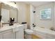 Bright bathroom with subway tile shower, black fixtures, and modern vanity at 785 Alice St, Forest Park, GA 30297