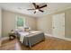 Bright bedroom with hardwood floors, side table, and a large window at 785 Alice St, Forest Park, GA 30297