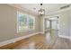 Dining room with hardwood floors, neutral paint, and a view into the living room at 785 Alice St, Forest Park, GA 30297