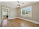 Light-filled dining room with hardwood floors, large windows, and view to other rooms at 785 Alice St, Forest Park, GA 30297