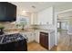 Updated kitchen featuring white cabinets, granite countertops, and stainless steel appliances at 785 Alice St, Forest Park, GA 30297