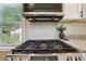 Close-up of a modern stainless steel gas stove in a well-lit kitchen with white subway tile backsplash at 785 Alice St, Forest Park, GA 30297
