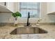 Kitchen sink with granite countertop, black faucet, and bright natural light at 785 Alice St, Forest Park, GA 30297