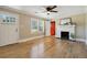 Sun-filled living room featuring gleaming hardwood floors, a decorative fireplace, and neutral paint at 785 Alice St, Forest Park, GA 30297