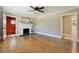 Bright living room with hardwood floors, a white fireplace, and a view into the bedroom and bathroom at 785 Alice St, Forest Park, GA 30297